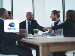 Business meeting at conference table - two people shaking hands